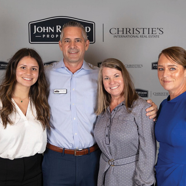Wilson Creative Group staff members posing with elite client John R Wood in Naples, Florida