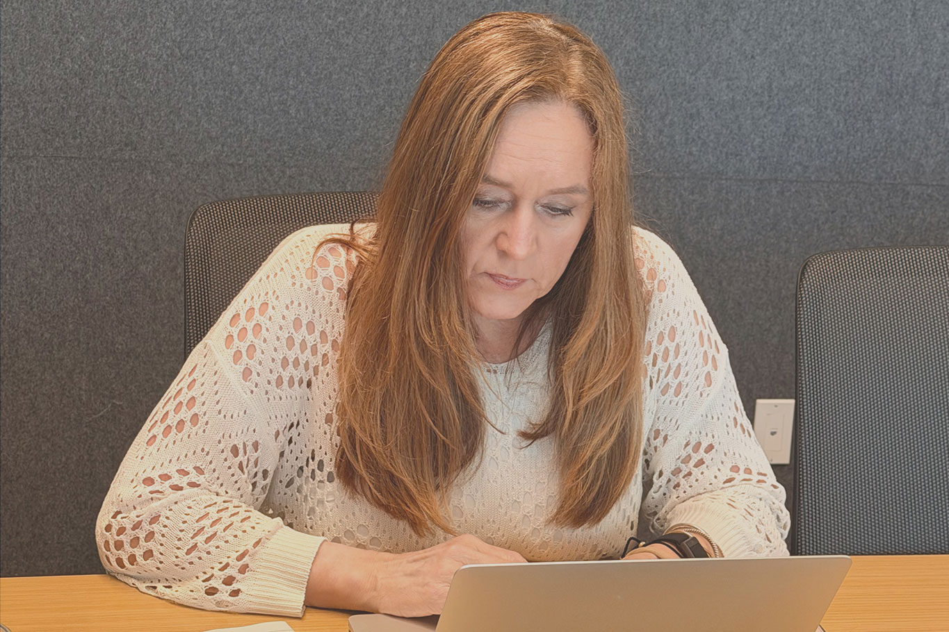 WCG staff member Jama Dock writing on her laptop